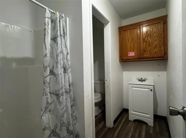 a bathroom with a granite countertop sink and a window