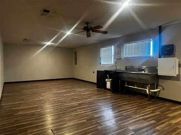 a room with wooden floor and furniture