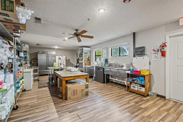 a living room with lots of furniture and a kitchen view
