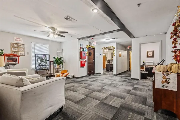 a living room with furniture a dining table and a couch