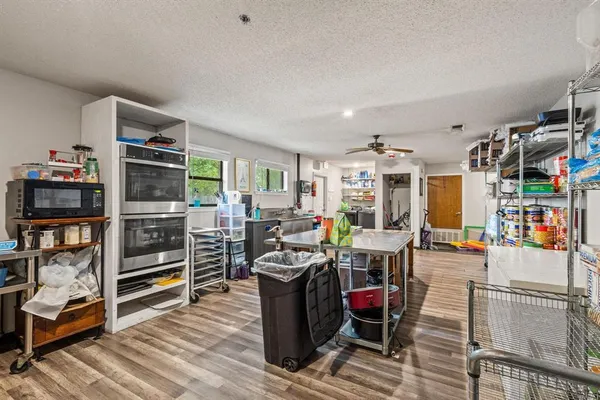 a living room with furniture a flat screen tv and gym equipment