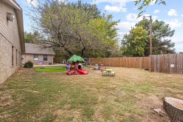 a view of a backyard with a sitting area and slide