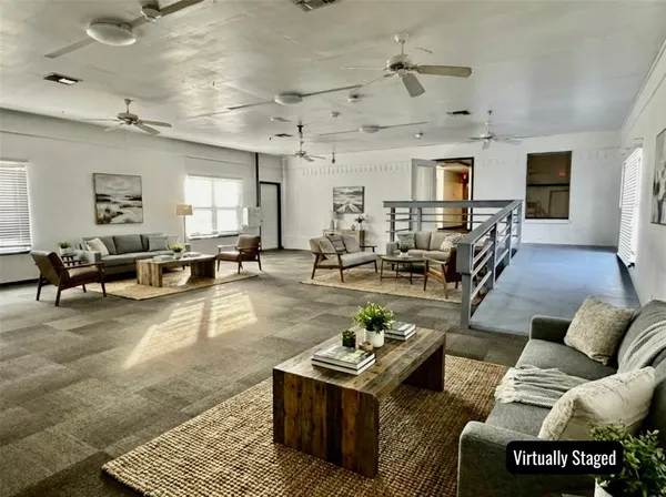 a living room with furniture kitchen view and a table