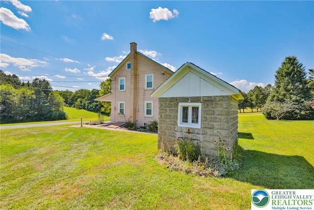 a view of a house with pool and yard