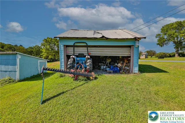 a view of a porch with furniture and a yard