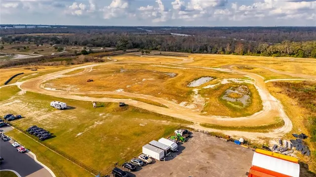 an aerial view of a swimming pool and outdoor seating
