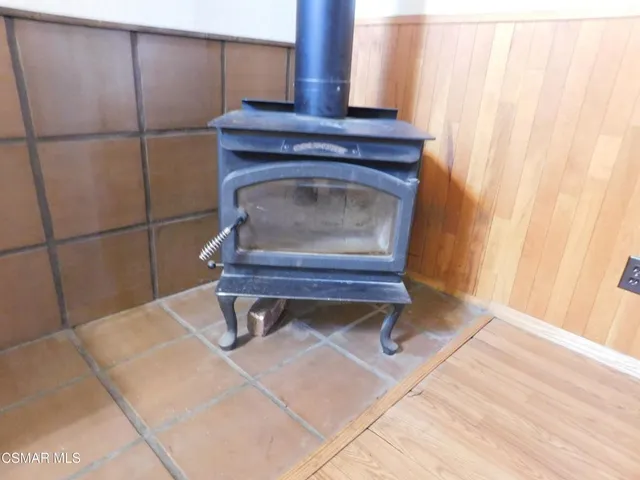 a living room with a wooden floor and a potted plant