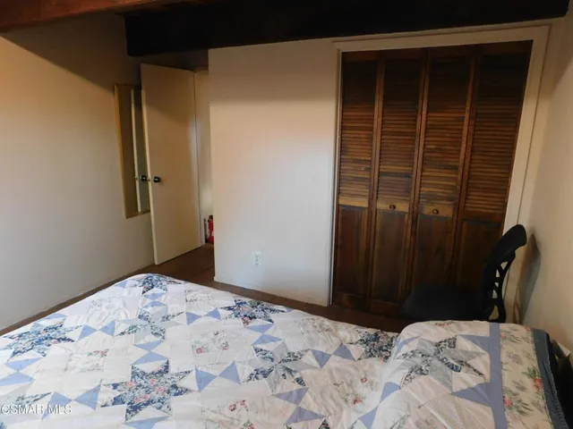 a bed sitting in a bedroom next to a window