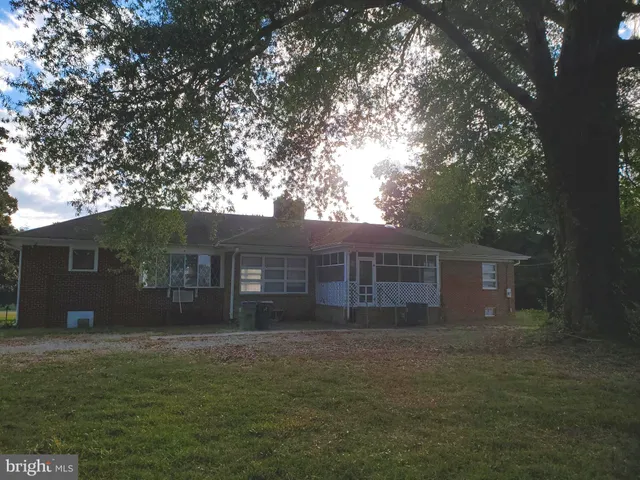 a front view of house with yard and trees