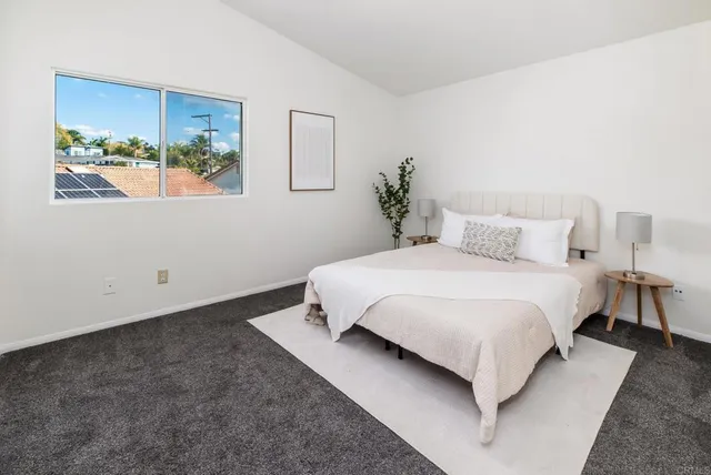 a bathroom with a granite countertop sink a mirror a vanity and shower