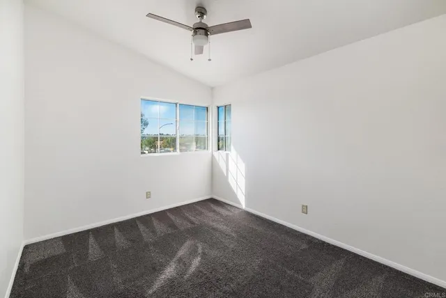 a view of a room that has wooden floor and window
