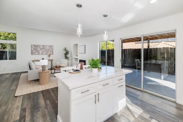 a living room with furniture a fireplace and a table