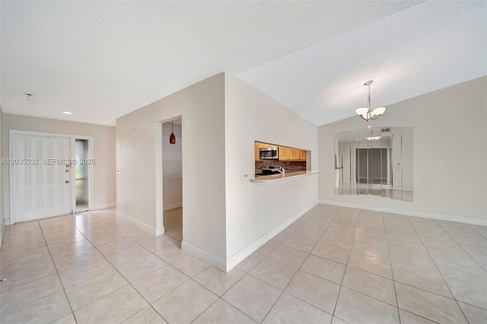 5223 Gate Lake Road, Unit 5223 Tamarac, FL 33319 - Photo 6 of 37 a view of a kitchen with furniture and an empty room