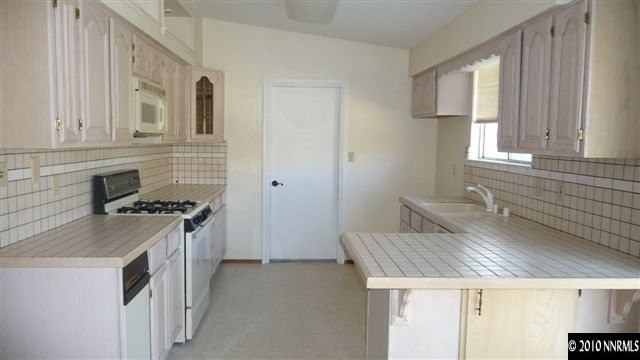 3455 Canvasback Lane Reno, NV 89508 - Photo 5 of 9 a kitchen with a stove and a white refrigerator
