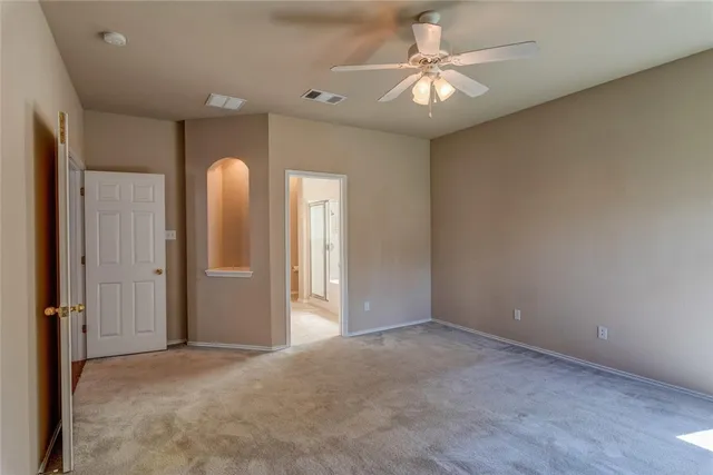 a view of entryway and hall with a chandelier fan