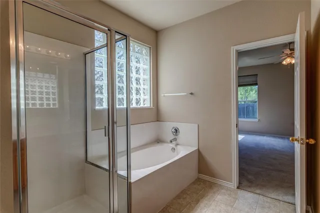 a bathroom with a bathtub and shower