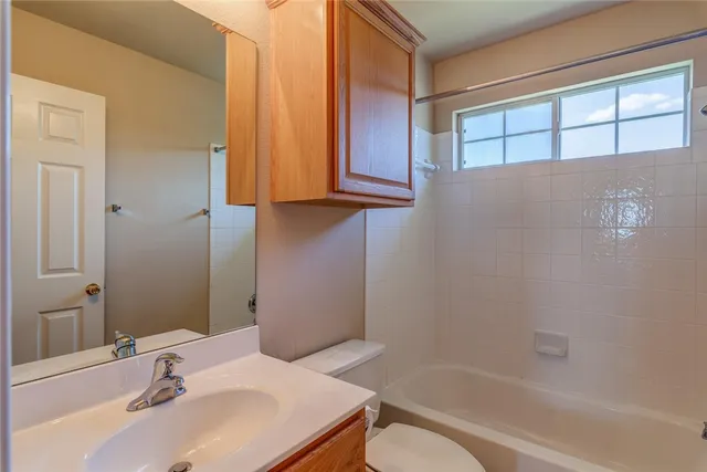 an empty room with an entryway and window