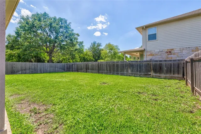 a view of a house with a yard and sitting area