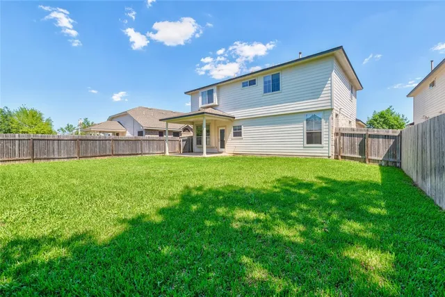 a view of a house with backyard and porch