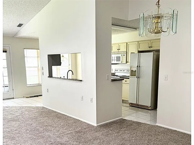 a view of a kitchen from a hallway