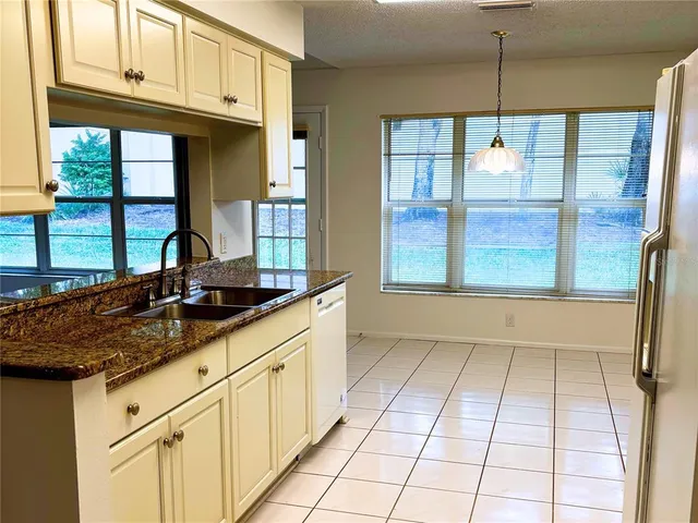 a kitchen with stainless steel appliances granite countertop a sink and a cabinets