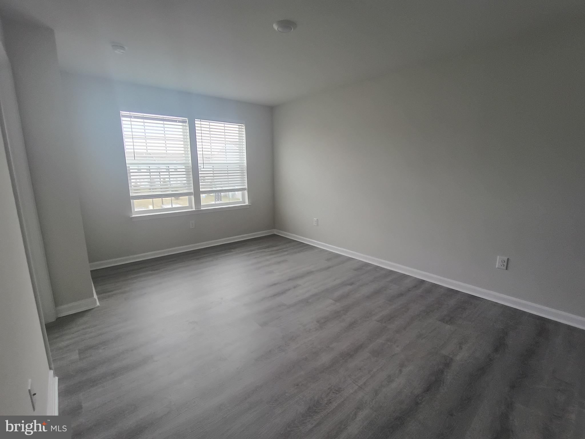 25 Elliot Lane Westampton, NJ 08060 - Photo 8 of 14 an empty room with wooden floor and windows