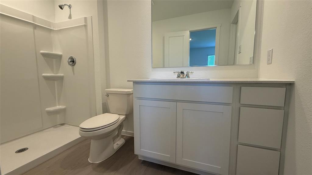 7701 Rutherford Lane McKinney, TX 75069 - Photo 17 of 20 a bathroom with a sink toilet and mirror