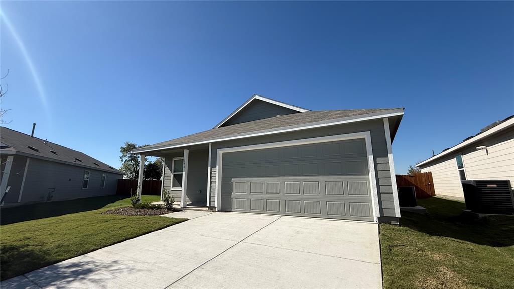 7701 Rutherford Lane McKinney, TX 75069 - Photo 2 of 20 a front view of a house with a yard and garage