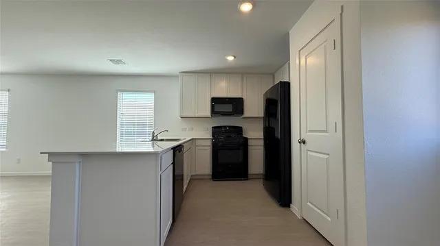 a kitchen with a refrigerator and a sink