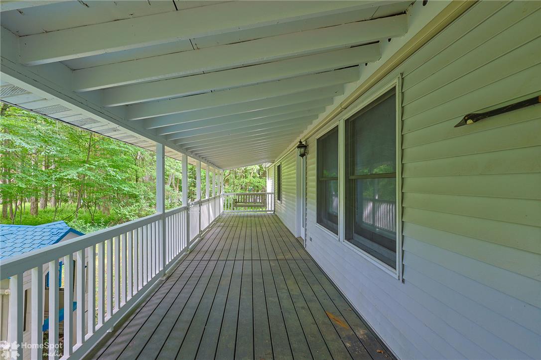 60 Sassafras Road Lehighton, PA 18235 - Photo 10 of 51 A deep covered porch provides a serene outdoor living space, overlooking a lush, private woodland.
