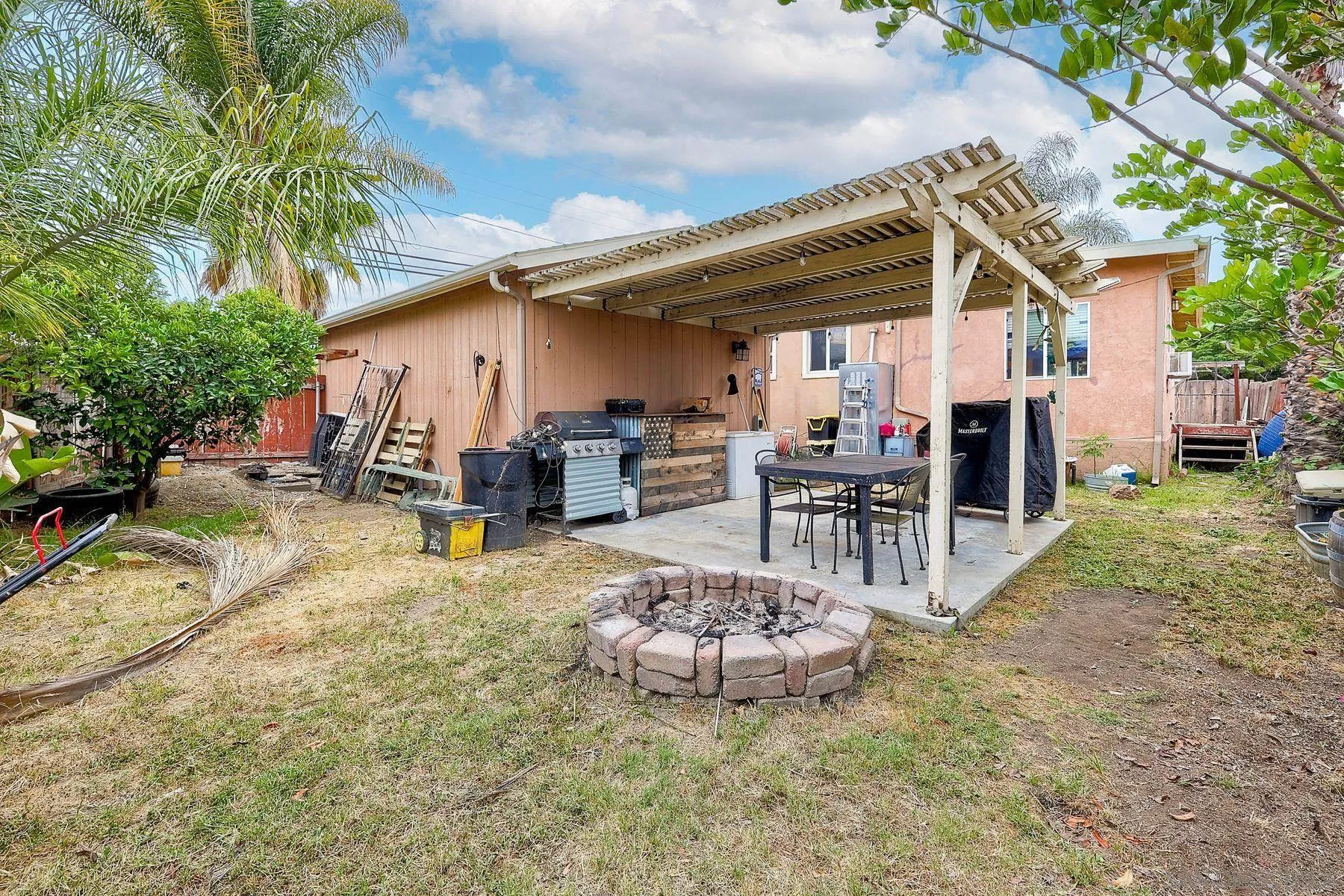9428 Prospect Avenue Santee, CA 92071 - Photo 23 of 23 a view of a patio with table and chairs potted plants and a large tree