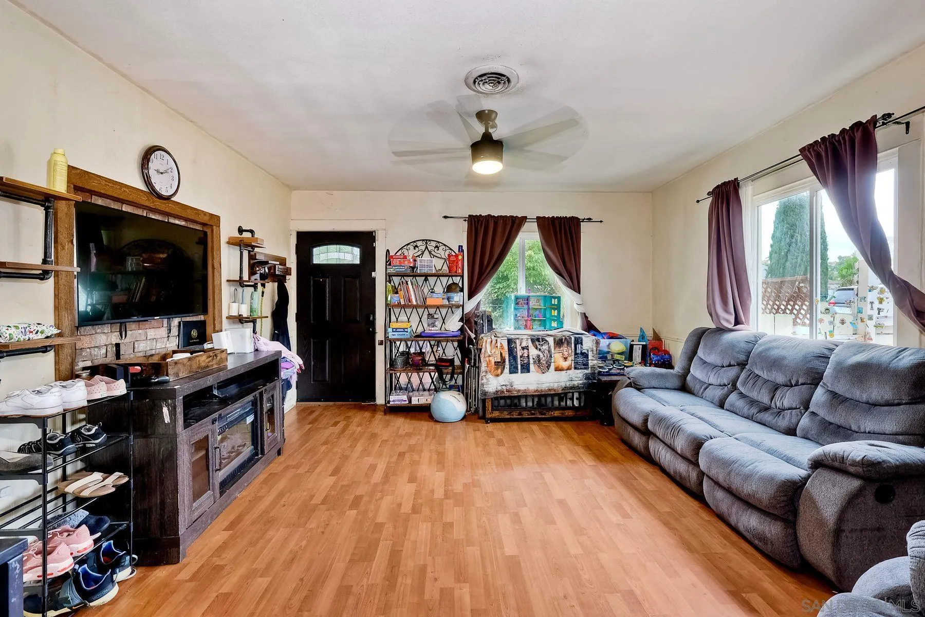 9428 Prospect Avenue Santee, CA 92071 - Photo 6 of 23 a living room with furniture and a flat screen tv