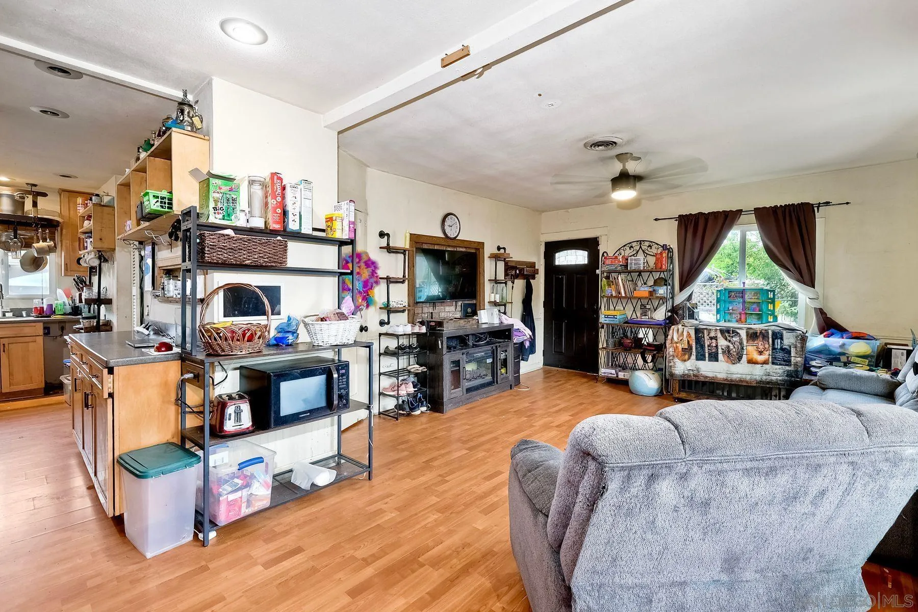 9428 Prospect Avenue Santee, CA 92071 - Photo 7 of 23 a living room with fireplace furniture and a flat screen tv