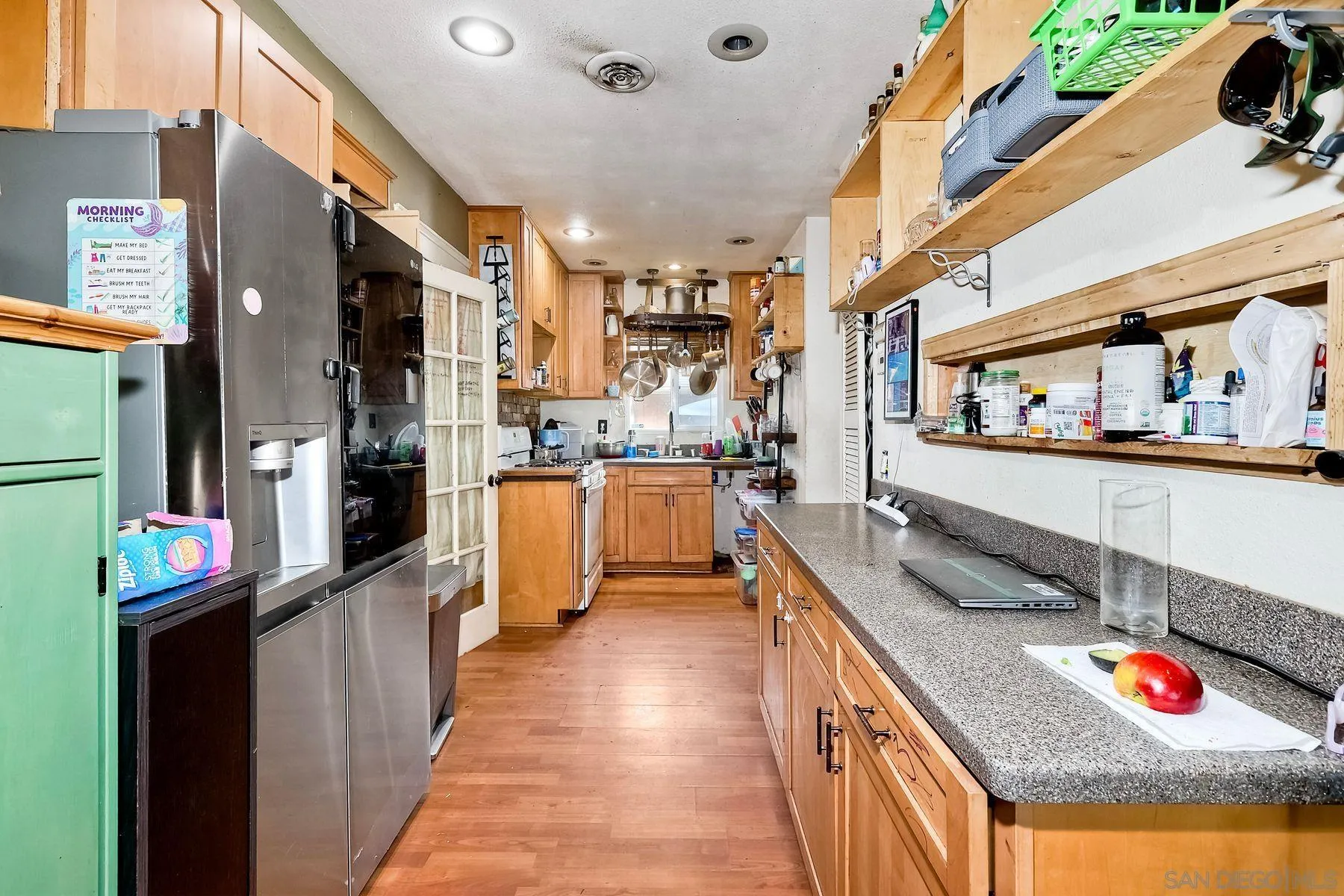 9428 Prospect Avenue Santee, CA 92071 - Photo 8 of 23 a kitchen with stainless steel appliances granite countertop a refrigerator and a stove