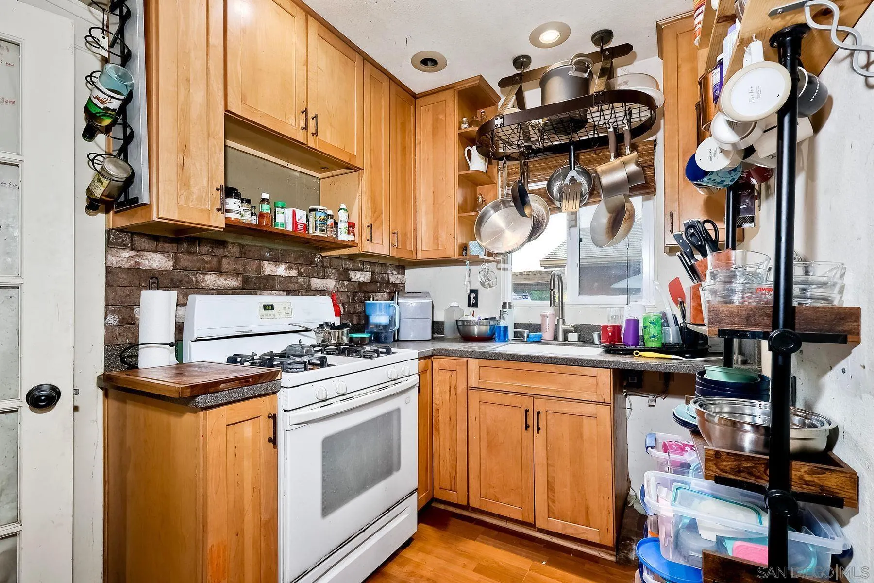 9428 Prospect Avenue Santee, CA 92071 - Photo 9 of 23 a kitchen with stainless steel appliances granite countertop a stove and a microwave