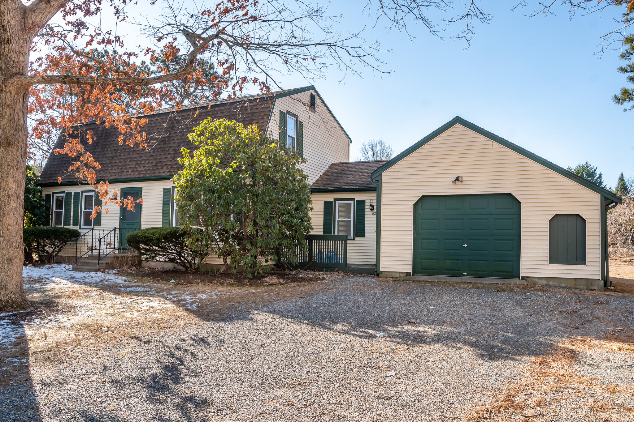 62 Windsor Road Sandwich, MA 02563 - Photo 2 of 24 a front view of a house with a yard and garage