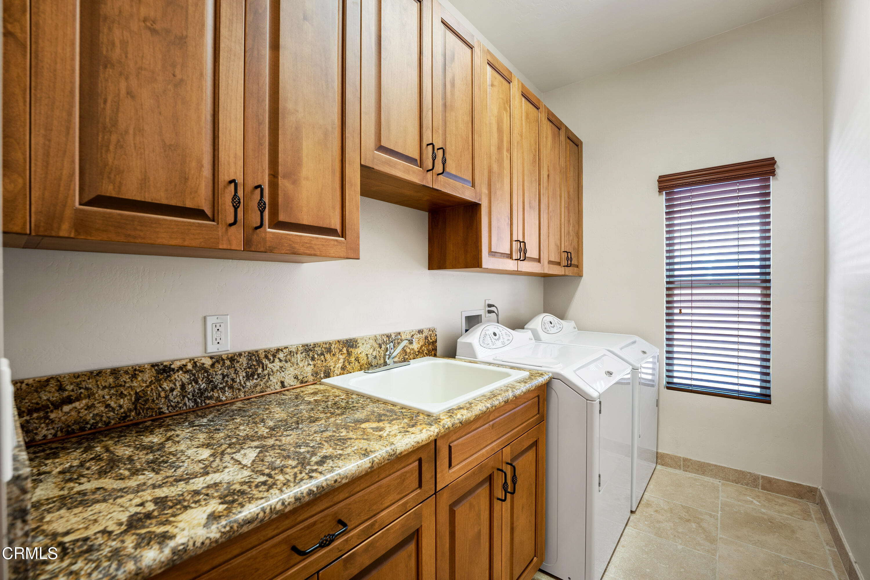 209 Ocean Drive Oxnard, CA 93035 - Photo 35 of 49 a kitchen with a sink a stove and cabinets