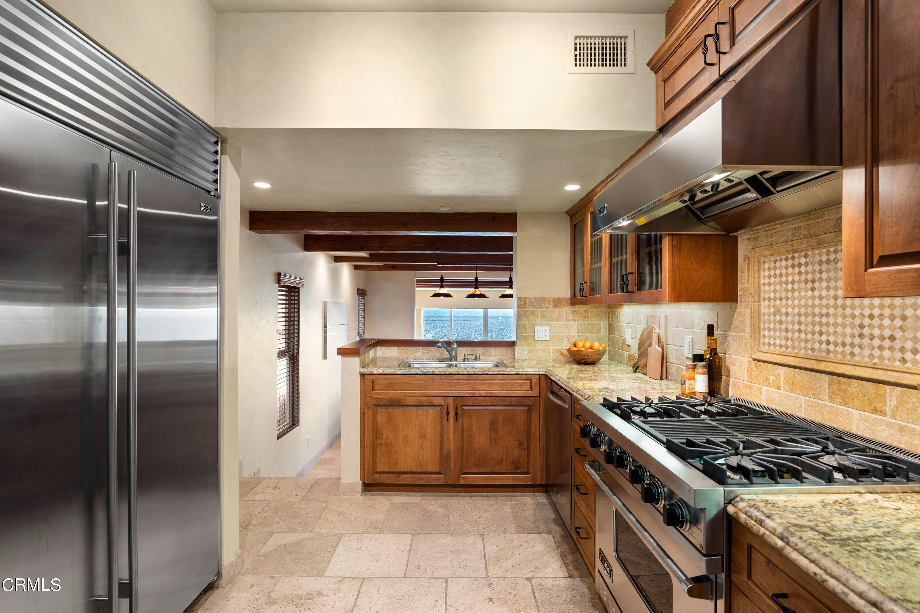 209 Ocean Drive Oxnard, CA 93035 - Photo 10 of 49 a kitchen with stainless steel appliances granite countertop a stove and a refrigerator