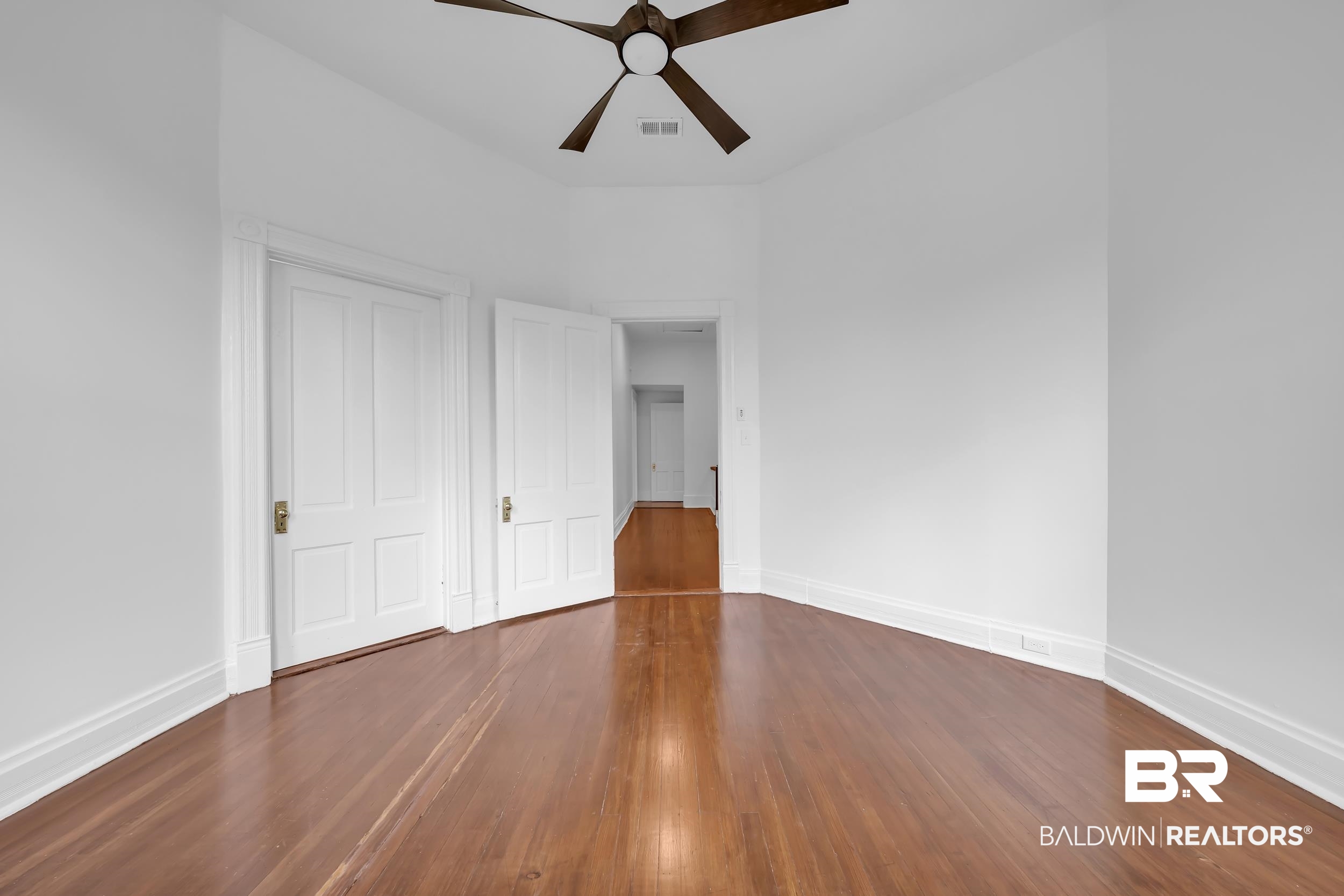 1662 Government Street Mobile, AL 36604 - Photo 29 of 33 Unfurnished bedroom featuring dark wood-style flooring and a ceiling fan