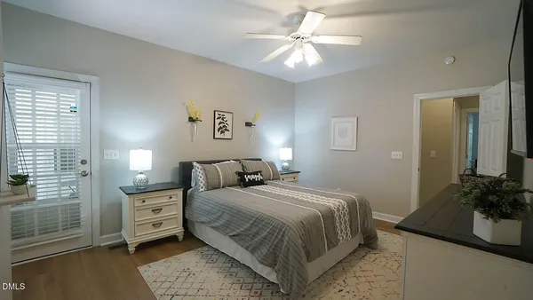 a bedroom with a bed a ceiling fan and a dresser