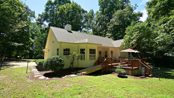 a front view of a house with yard and sitting area