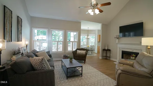 a living room with furniture a flat screen tv and a fireplace