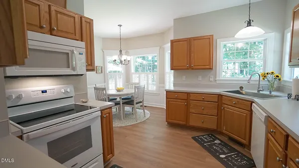 a kitchen with a stove a sink and cabinets