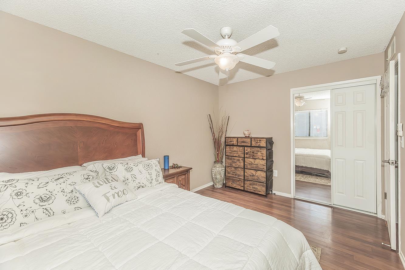 1908 East Niles Avenue Fresno, CA 93720 - Photo 20 of 30 a bedroom with a bed and a chandelier
