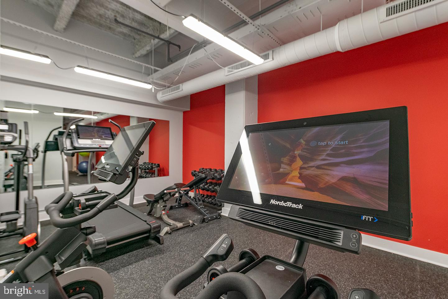 412 South 13th Street, Unit 212 Philadelphia, PA 19147 - Photo 11 of 16 a room with gym equipment and mirror