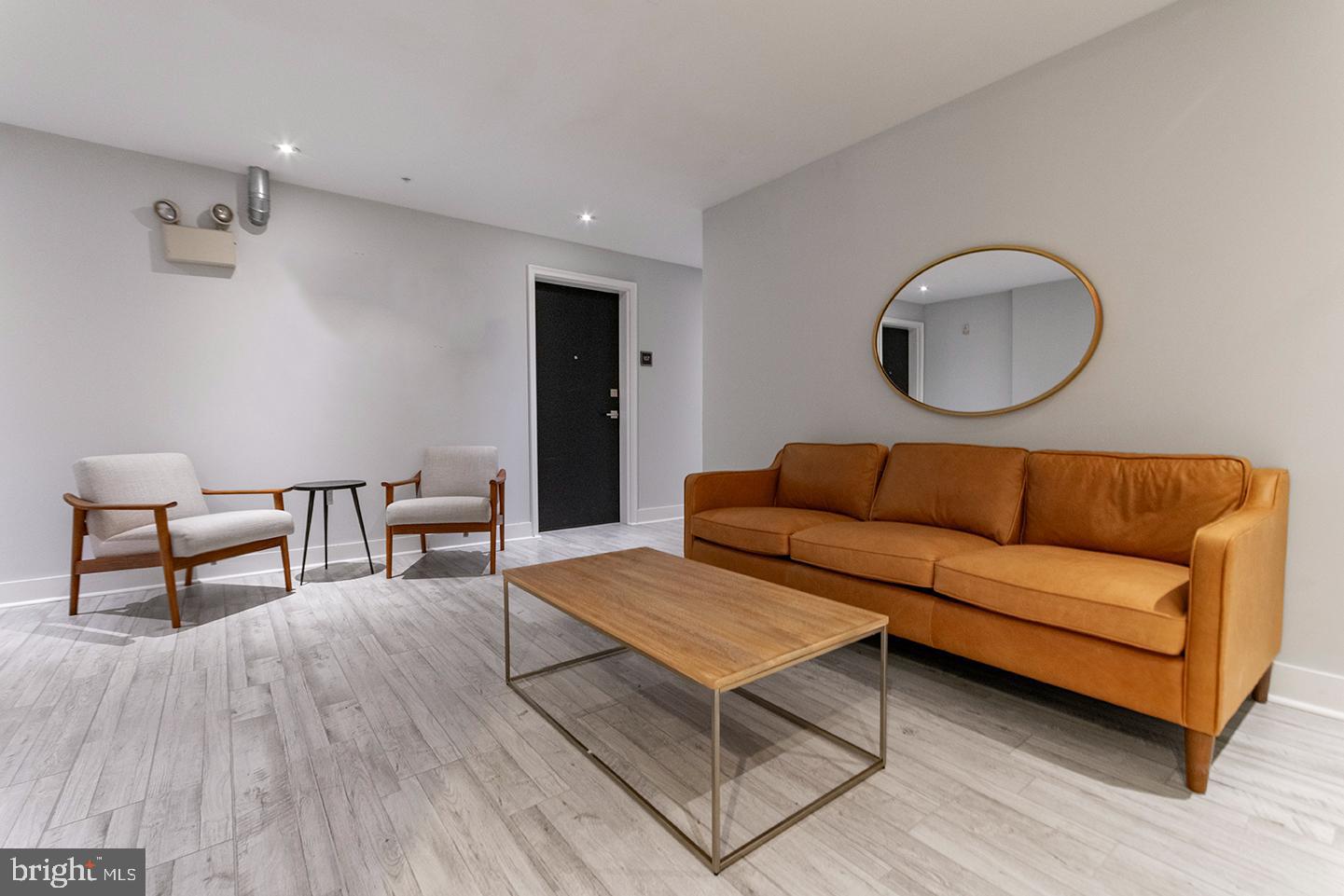 412 South 13th Street, Unit 212 Philadelphia, PA 19147 - Photo 12 of 16 a living room with furniture and a wooden floor