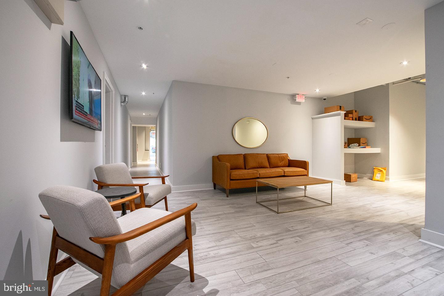 412 South 13th Street, Unit 212 Philadelphia, PA 19147 - Photo 13 of 16 a living room with furniture and a wooden floor