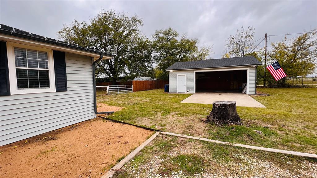 7301 Fishtrap Road Cross Roads, TX 76227 - Photo 12 of 40 a backyard of a house with barbeque oven and yard in the back