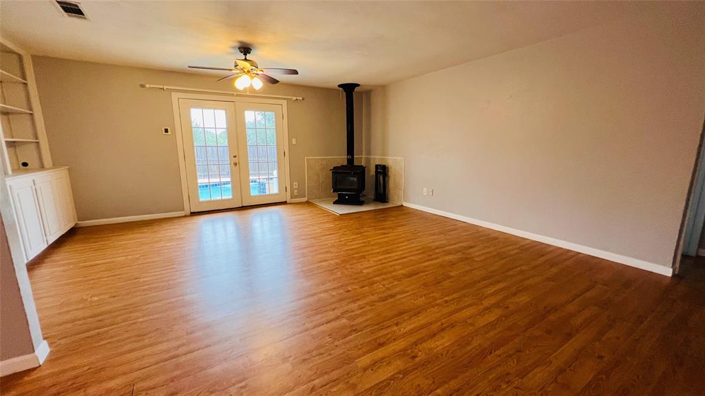 7301 Fishtrap Road Cross Roads, TX 76227 - Photo 16 of 40 a view of an empty room with wooden floor and a window