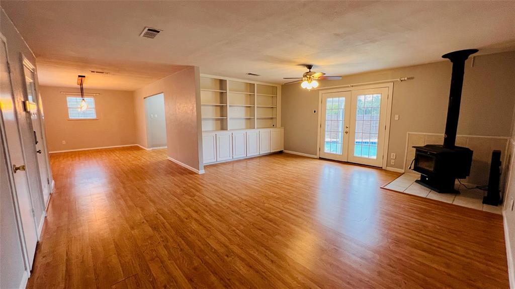 7301 Fishtrap Road Cross Roads, TX 76227 - Photo 17 of 40 a view of an empty room with wooden floor and a window